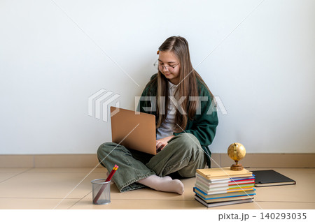 Teenage student holding a laptop on white background Teenage student holding a laptop on white background 140293035