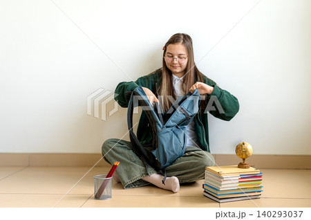 Teenage student holding books on white background 140293037