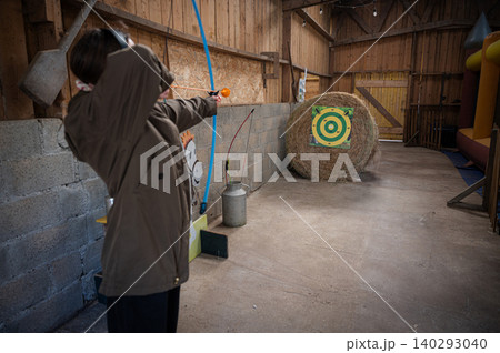 Girl Practicing with Bow and Arrows Girl Practicing with Bow and Arrows 140293040