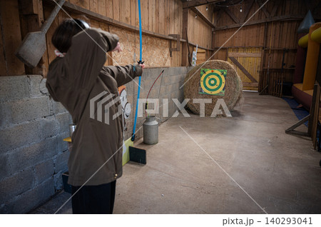 Girl Practicing with Bow and Arrows Girl Practicing with Bow and Arrows 140293041