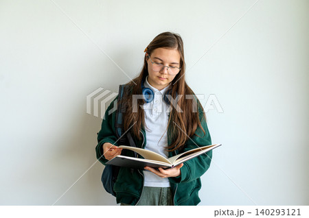 Teenage student holding books on white background Teenage student holding books on white background 140293121