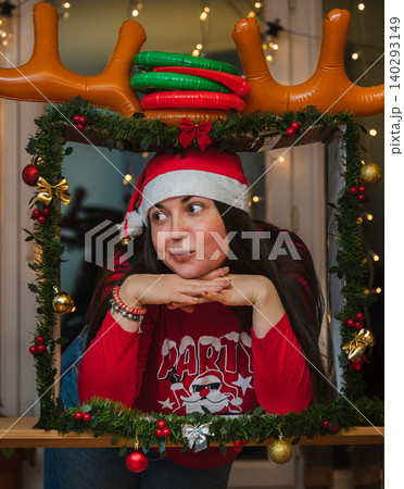 Woman in Santa Hat Glancing Aside in Christmas Frame 140293149