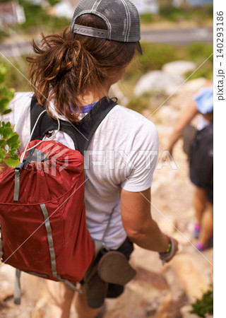 Woman, hiking and backpack on mountain for fitness, adventure or rocky trail of outdoor path in nature. Rear view of female person or hiker walking down cliff in extreme trekking or adventure outside Woman, hiking and backpack on mountain for fitness, adventure or rocky trail of outdoor path in nature. Rear view of female person or hiker walking down cliff in extreme trekking or adventure outside 140293186