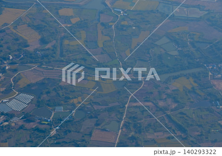 The view of China city from the airplane window. Aerial view of cityscape, the land of China, Asia. Travel and landscape scene. Travel and nature concept. The view of China city from the airplane window. Aerial view of cityscape, the land of China, Asia. Travel and landscape scene. Travel and nature concept. 140293322