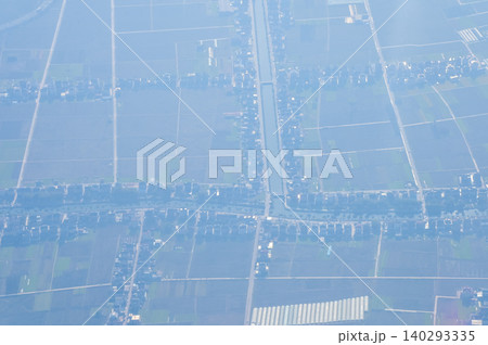 The view of China city from the airplane window. Aerial view of cityscape, the land of China, Asia. Travel and landscape scene. Travel and nature concept.  140293335