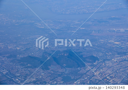 The view of China city from the airplane window. Aerial view of cityscape, the land of China, Asia. Travel and landscape scene. Travel and nature concept. The view of China city from the airplane window. Aerial view of cityscape, the land of China, Asia. Travel and landscape scene. Travel and nature concept. 140293348