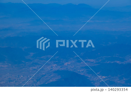 The view of China city from the airplane window. Aerial view of cityscape, the land of China, Asia. Travel and landscape scene. Travel and nature concept.  140293354