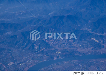 The view of China city from the airplane window. Aerial view of cityscape, the land of China, Asia. Travel and landscape scene. Travel and nature concept. The view of China city from the airplane window. Aerial view of cityscape, the land of China, Asia. Travel and landscape scene. Travel and nature concept. 140293357