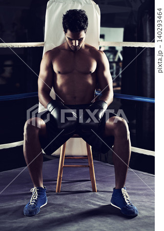 Workout, man and boxing ring for sports, corner or training for competition in gym for body health. Fighter, strong athlete and serious person with gloves for fitness, exercise and muscle at club 140293464