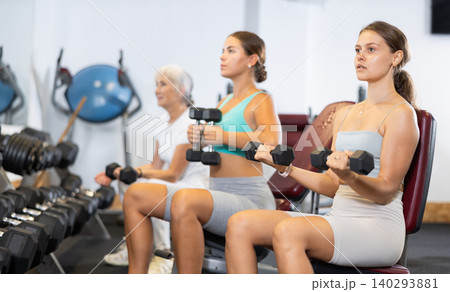 Group of women training with dumbbells in gym Group of women training with dumbbells in gym 140293881
