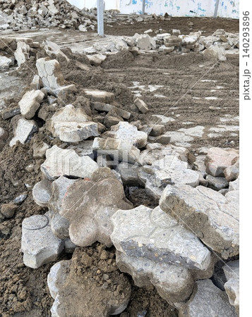 a chaotic pile of broken concrete debris and shattered paving stones mixed with loose, brown soil. Sidewalk repair a chaotic pile of broken concrete debris and shattered paving stones mixed with loose, brown soil. Sidewalk repair 140293896