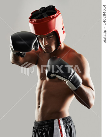 Man, portrait and in studio with boxing gear for safety while fighting, tough and serious for competition. Male person, protection wear and ready for self defense match, mma and physical sports Man, portrait and in studio with boxing gear for safety while fighting, tough and serious for competition. Male person, protection wear and ready for self defense match, mma and physical sports 140294014