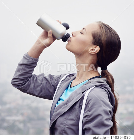 Woman, drink and water bottle for fitness, detox and wellness on cloudy day in France with mockup. Thirsty female person, sportswear and hydrate with exercise, training and workout for health Woman, drink and water bottle for fitness, detox and wellness on cloudy day in France with mockup. Thirsty female person, sportswear and hydrate with exercise, training and workout for health 140294050