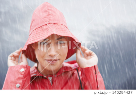 Woman, smile and portrait with rain, coat and clouds with happiness in nature. Person, face and storm with cloudy, winter and waterproof hat for protection and confidence with safety or adventure Woman, smile and portrait with rain, coat and clouds with happiness in nature. Person, face and storm with cloudy, winter and waterproof hat for protection and confidence with safety or adventure 140294427