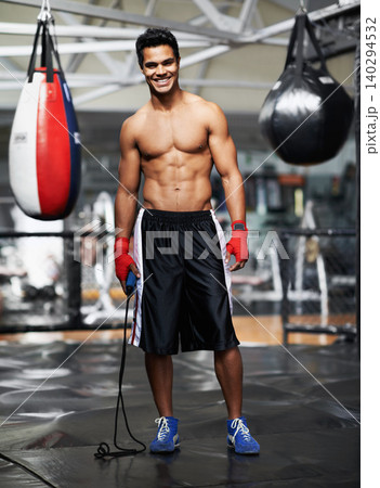 Man, portrait and equipment in gym for boxing, training and keeping fit for competition. Male person, mma fighter and exercise in fitness centre for wellness, health and maintain strength for match Man, portrait and equipment in gym for boxing, training and keeping fit for competition. Male person, mma fighter and exercise in fitness centre for wellness, health and maintain strength for match 140294532