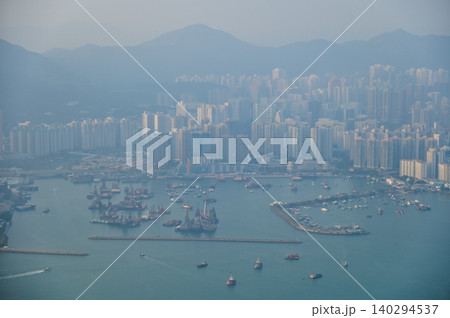 Looking from the airplane window with Hong Kong cityscape. The view of Hong Kong city, Hong Kong landscape from the above. Landscape, travel concept and nature scene.  140294537