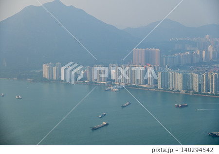 Looking from the airplane window with Hong Kong cityscape. The view of Hong Kong city, Hong Kong landscape from the above. Landscape, travel concept and nature scene. Looking from the airplane window with Hong Kong cityscape. The view of Hong Kong city, Hong Kong landscape from the above. Landscape, travel concept and nature scene. 140294542