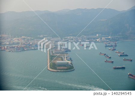 Looking from the airplane window with Hong Kong cityscape. The view of Hong Kong city, Hong Kong landscape from the above. Landscape, travel concept and nature scene. Looking from the airplane window with Hong Kong cityscape. The view of Hong Kong city, Hong Kong landscape from the above. Landscape, travel concept and nature scene. 140294545