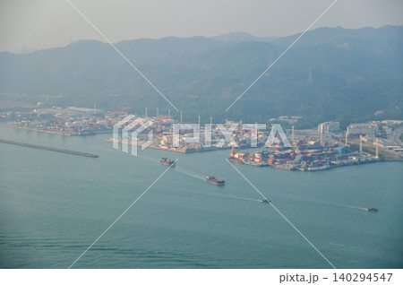 Looking from the airplane window with Hong Kong cityscape. The view of Hong Kong city, Hong Kong landscape from the above. Landscape, travel concept and nature scene. Looking from the airplane window with Hong Kong cityscape. The view of Hong Kong city, Hong Kong landscape from the above. Landscape, travel concept and nature scene. 140294547