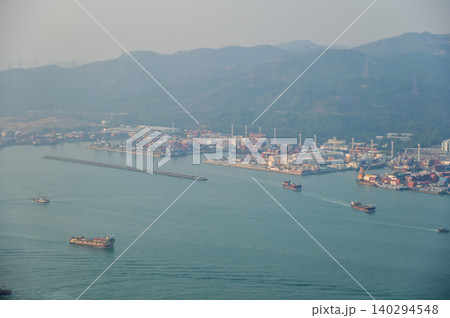 Looking from the airplane window with Hong Kong cityscape. The view of Hong Kong city, Hong Kong landscape from the above. Landscape, travel concept and nature scene. Looking from the airplane window with Hong Kong cityscape. The view of Hong Kong city, Hong Kong landscape from the above. Landscape, travel concept and nature scene. 140294548