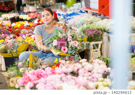 Female shopper chooses a chic bouquet of flowers at flower market Female shopper chooses a chic bouquet of flowers at flower market 140294813