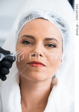 Woman receiving skincare treatment in a spa environment during daytime 140295161