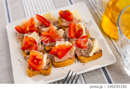 There are sandwiches canape with pate, cheese and tomato on plate. 140295192