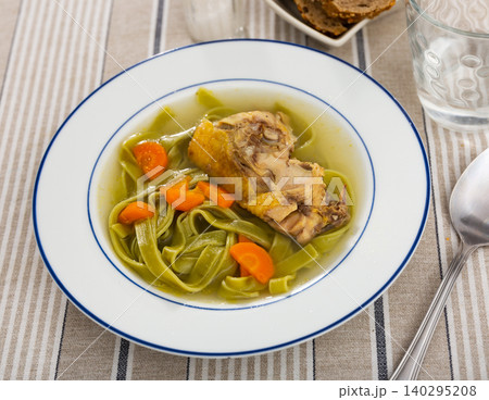 Delicious chicken soup with pasta and carrots 140295208
