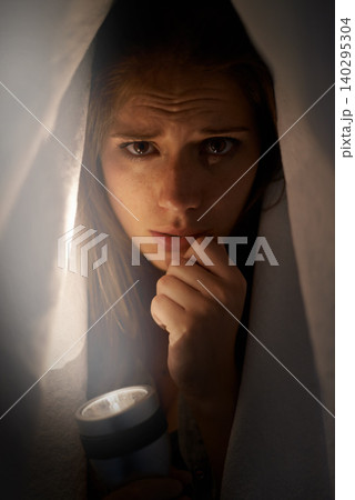 Woman, flashlight and portrait with blanket for mental health, horror or anxiety. Young person and scared or sad with depression, ocd or horror for financial crisis, stress and disappointment 140295304
