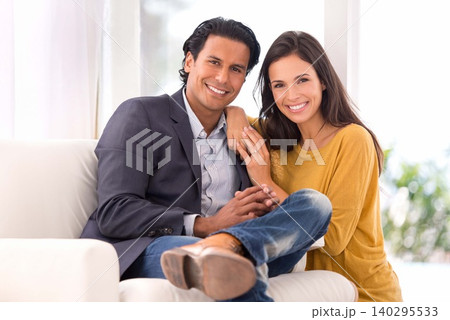 Smile, love and couple on chair in living room at home with comfortable romance and care. Happy, marriage and portrait of young man and woman sitting on sofa together in lounge at modern house. Smile, love and couple on chair in living room at home with comfortable romance and care. Happy, marriage and portrait of young man and woman sitting on sofa together in lounge at modern house. 140295533