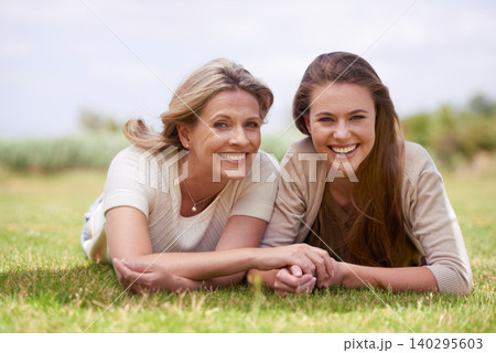 Women, mother and daughter with holding hands, grass and mature person with connection, care and love. Mom, girl and family with bonding, reunion and vacation with lawn, happy and together in spring Women, mother and daughter with holding hands, grass and mature person with connection, care and love. Mom, girl and family with bonding, reunion and vacation with lawn, happy and together in spring 140295603