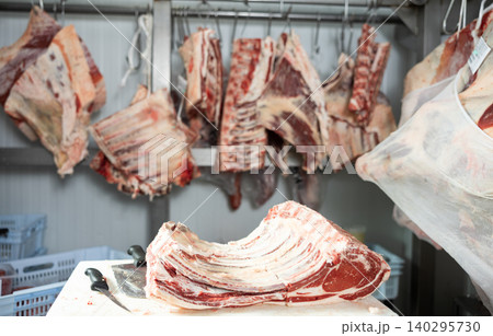 Raw beef ribs lying on cutting table in butcher shop Raw beef ribs lying on cutting table in butcher shop 140295730