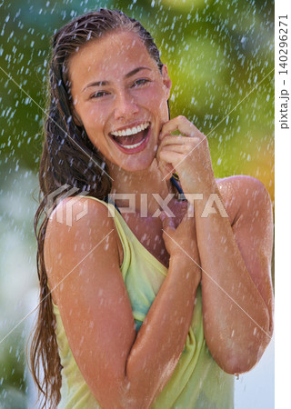 Woman, rain and portrait with laughing from summer climate, water and weather outdoor in park. Happy, travel and female person with funny joke from raindrops on holiday and vacation with trip and joy 140296271