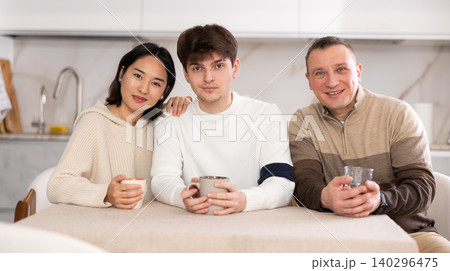 Adult man and sitting at table in kitchen Adult man and sitting at table in kitchen 140296475