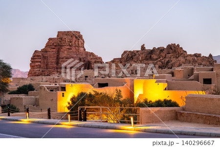 View of the traditional mud brick architecture and historic fort of AlUla Old Town illuminated at twilight in Saudi Arabia. View of the traditional mud brick architecture and historic fort of AlUla Old Town illuminated at twilight in Saudi Arabia. 140296667