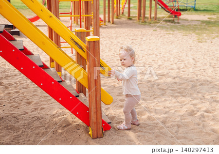 Little girl playing on a playground Little girl playing on a playground 140297413