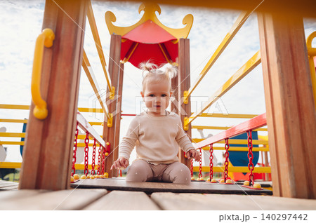 Happy child having fun on a playground Happy child having fun on a playground 140297442