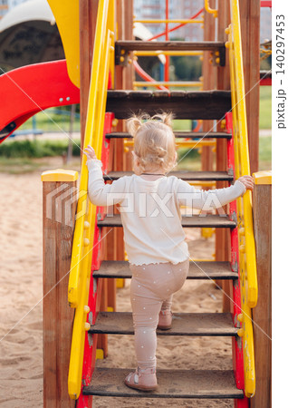 Little girl playing on a playground Little girl playing on a playground 140297453