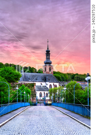 A scenic view of the Schlosskirche and Saarbrucken Castle under a vibrant purple sunset in Saarland, Germany. A scenic view of the Schlosskirche and Saarbrucken Castle under a vibrant purple sunset in Saarland, Germany. 140297510
