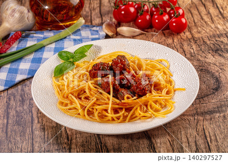 Spaghetti meatballs, fresh basil garnish, rustic wood table. Italian pasta dish, cherry tomatoes, garlic, chili Spaghetti meatballs, fresh basil garnish, rustic wood table. Italian pasta dish, cherry tomatoes, garlic, chili 140297527