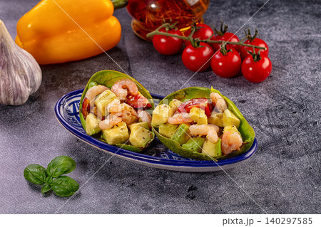 Shrimp avocado salad in avocado boats with fresh tomatoes and pepper Shrimp avocado salad in avocado boats with fresh tomatoes and pepper 140297585