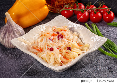 Fermented cabbage salad with cranberries and fresh vegetables on dark background 140297588