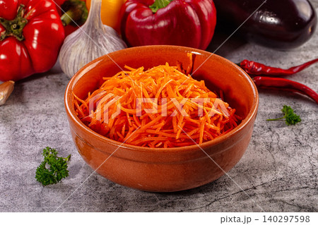 Spicy Korean carrot salad in ceramic bowl with fresh vegetables Spicy Korean carrot salad in ceramic bowl with fresh vegetables 140297598