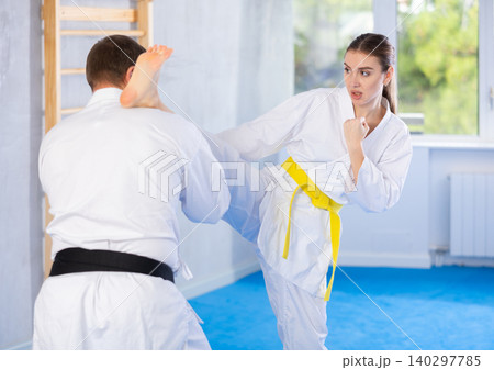Woman and man in kimono exercising Woman and man in kimono exercising 140297785