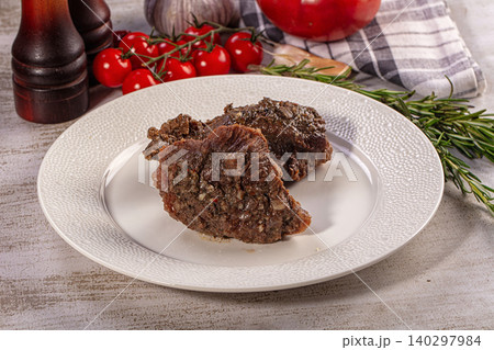 Delicious Beef Cheek Serving with Rosemary and Tomatoes on Rustic Table Delicious Beef Cheek Serving with Rosemary and Tomatoes on Rustic Table 140297984