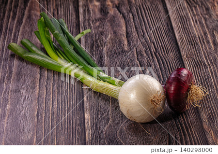 Fresh White Red and Green Onions on Dark Wood Background Fresh White Red and Green Onions on Dark Wood Background 140298000