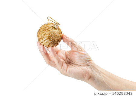 Woman's hand holding a Christmas ball on the white background. 140298342