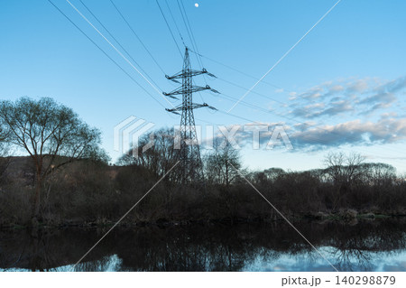 Electric Power Tower Above Riverside Trees Electric Power Tower Above Riverside Trees 140298879