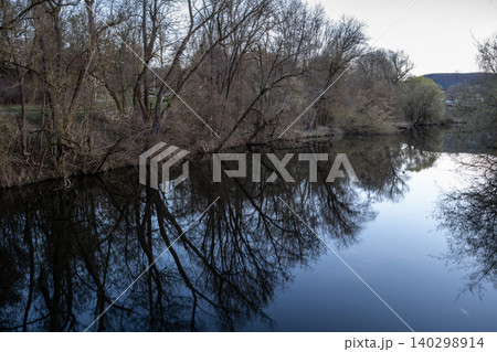 Dark Tree Reflections On Calm River Dark Tree Reflections On Calm River 140298914