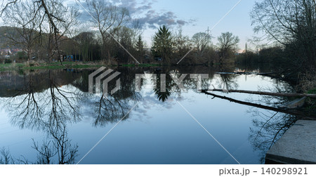 Calm River Reflection With Fallen Tree Calm River Reflection With Fallen Tree 140298921
